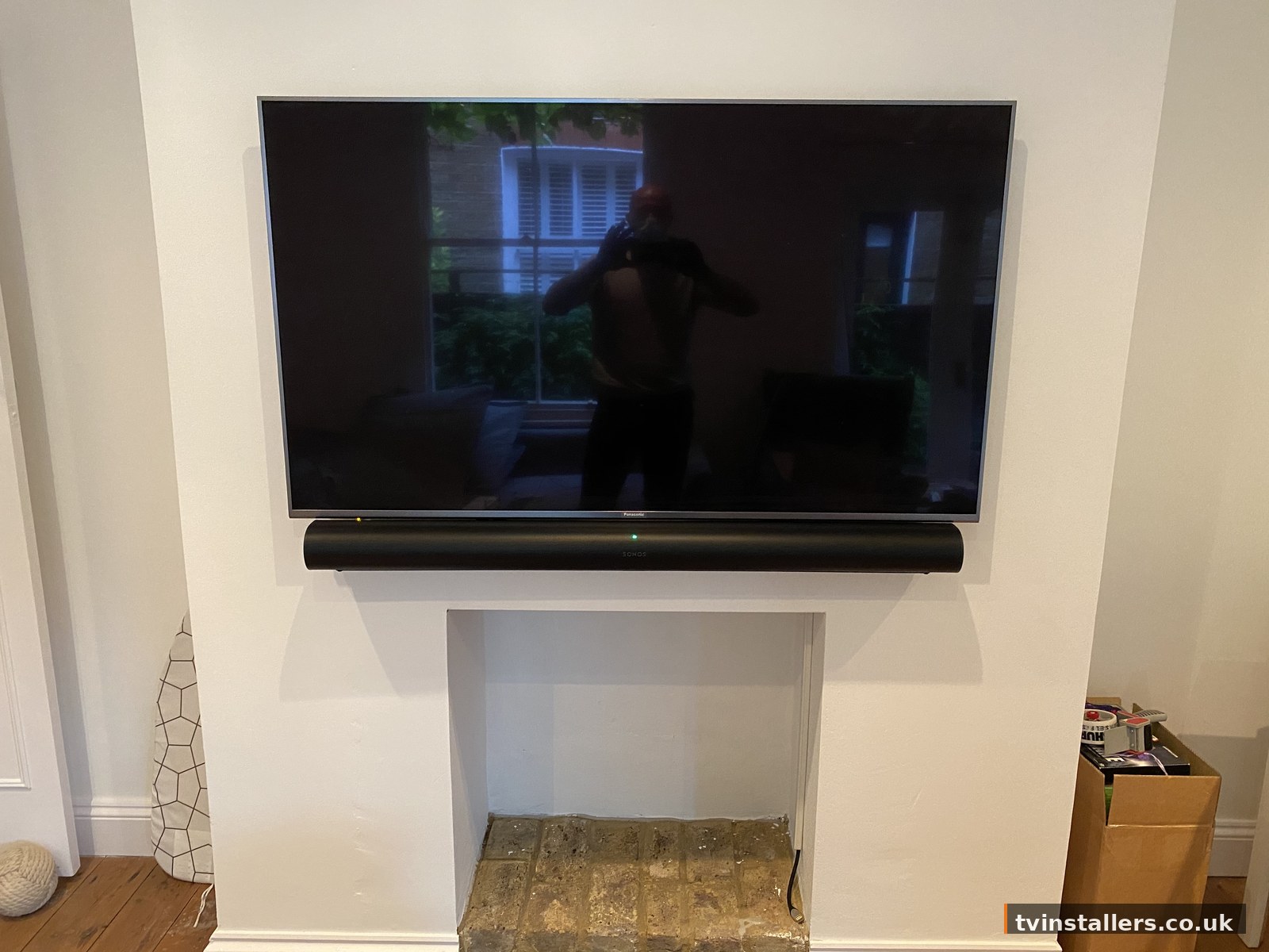 TV above fireplace with soundbar